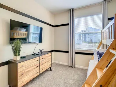 a bedroom with a wooden dresser and a window at Homely Lakeview 3BR Condo with Waterpark in Kissimmee