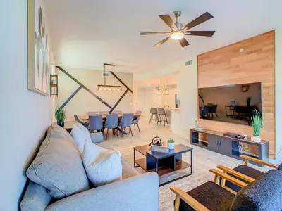 a living room with a couch and a dining room at Homely Lakeview 3BR Condo with Waterpark in Kissimmee