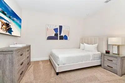 a white bedroom with a bed and a dresser at Charming Home Near Disney With Private Pool And Waterpark & Resort Access At Encore Resorts Reunion - 7389Mr in Kissimmee