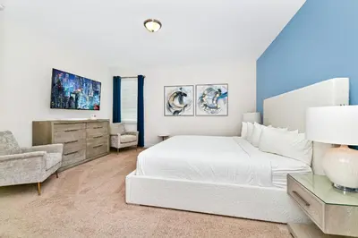 a white bedroom with a bed and a chair at Charming Home Near Disney With Private Pool And Waterpark & Resort Access At Encore Resorts Reunion - 7389Mr in Kissimmee