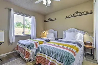 two beds in a room with a window at about 9 Mi to Universal Orlando Retreat with Sun Porch! in Orlando