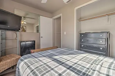 a bedroom with a bed and a dresser and a tv at about 9 Mi to Universal Orlando Retreat with Sun Porch! in Orlando