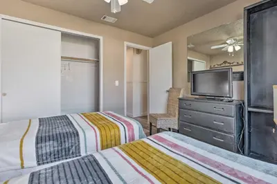 a bedroom with two beds and a flat screen tv at about 9 Mi to Universal Orlando Retreat with Sun Porch! in Orlando