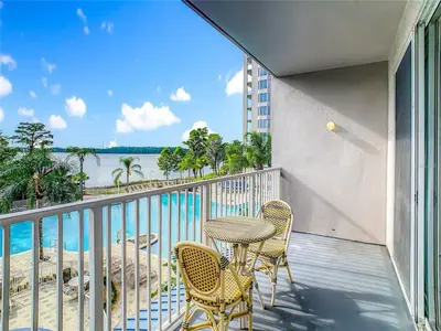 a balcony with a table and chairs and a view of the ocean at Disney 1 mile , Blue Heron 1 room 2 bath,amenities,6 guests, walk to restaurants, no fees at check in in Orlando
