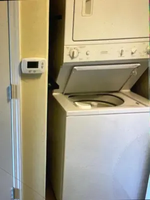 a white washer and dryer in a room at Disney 1 mile , Blue Heron 1 room 2 bath,amenities,6 guests, walk to restaurants, no fees at check in in Orlando