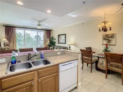 a kitchen with a sink and a dining room at Disney 1 mile , Blue Heron 1 room 2 bath,amenities,6 guests, walk to restaurants, no fees at check in in Orlando
