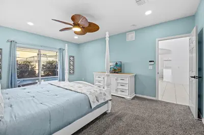 a blue bedroom with a bed and a ceiling fan at Near Disney, Recently Renovated, Clubhouse in Kissimmee