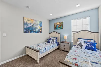two beds in a bedroom with blue walls at Near Disney, Recently Renovated, Clubhouse in Kissimmee