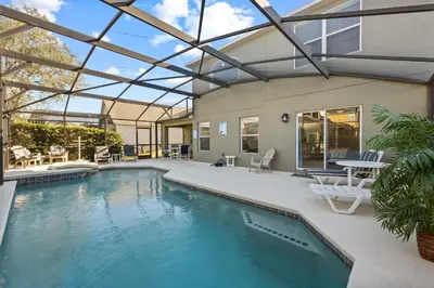 a swimming pool with a glass roof over a house at Near Disney, Recently Renovated, Clubhouse in Kissimmee