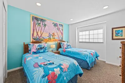 two beds in a room with blue walls at Near Disney, Recently Renovated, Clubhouse in Kissimmee