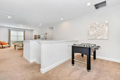 a living room with a table and a chess game at Vibrant Home Near Disney With Media Room, Themed Rooms, Game Room And Waterpark & Resort Access At Encore Resorts Reunion - 7450Mr in Kissimmee