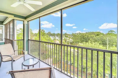 a screened porch with a chair and a table at Upstay - Pet-Friendly Suite w Pool, Sauna in Orlando