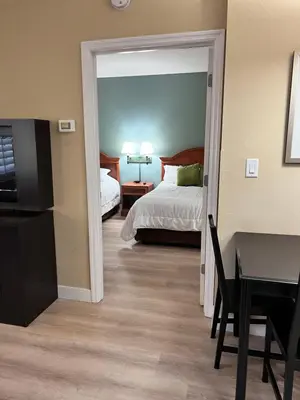 a hotel room with a bed and a desk and a bedroom at Great Condo Incredible Location in Orlando