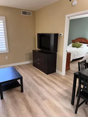 a living room with a flat screen tv and a bed at Great Condo Incredible Location in Orlando