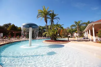 a large swimming pool with a fountain in the middle at 5366 Unit 17-106 Lovely home inside Disney area in Kissimmee