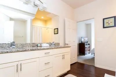 a bathroom with two sinks and a large mirror at 5366 Unit 17-106 Lovely home inside Disney area in Kissimmee