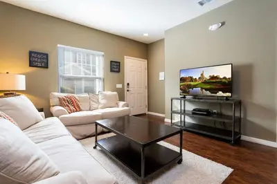 a living room with two white couches and a flat screen tv at 5366 Unit 17-106 Lovely home inside Disney area in Kissimmee
