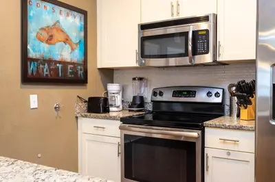 a kitchen with a stove and a microwave at 5366 Unit 17-106 Lovely home inside Disney area in Kissimmee