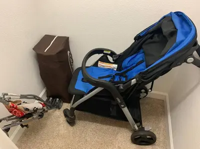 a blue and black stroller sitting next to a box at Excellent Resort Free/ Makin Memories / 4 Beds in Kissimmee