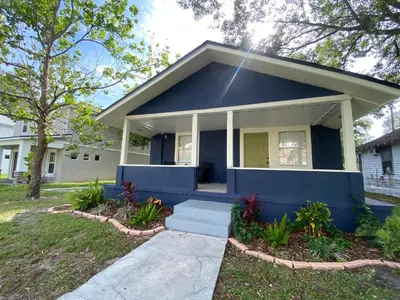a small blue house with a porch at Bella Breeze in Sanford