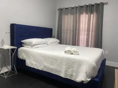a bedroom with a blue bed with towels on it at The Blue Aztec in Sanford
