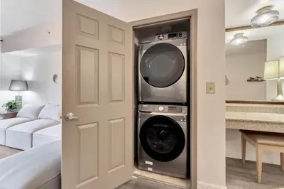 a washer and dryer in a living room at Designer 3BR/2BA Corner Suite - Disney & Universal in Orlando