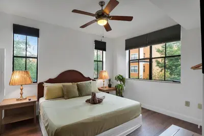 a bedroom with a bed with a ceiling fan at Designer 3BR/2BA Corner Suite - Disney & Universal in Orlando