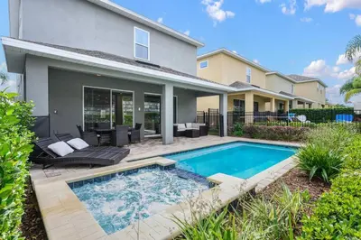 a swimming pool in front of a house at Luxurious Encore Villa 10 Min Disney Inc/Waterpark in Orlando