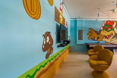 a room with a wall with cartoon characters on it at Luxurious Encore Villa 10 Min Disney Inc/Waterpark in Orlando