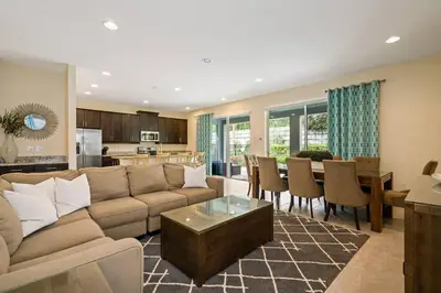 a living room with a couch and a dining room at Luxurious Encore Villa 10 Min Disney Inc/Waterpark in Orlando