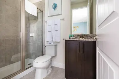 a bathroom with a toilet and a sink and a shower at Luxurious Encore Villa 10 Min Disney Inc/Waterpark in Orlando