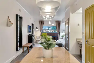 a living room with a potted plant on a counter at Designer Corner Suite 3BR/2BA -Disney & Universal in Orlando