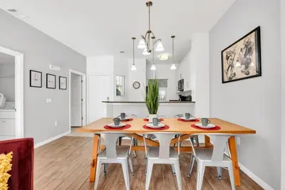 a kitchen and dining room with a wooden table and chairs at Newly Renovated Stylish Villa with Star Wars Mickey and Safari Themed Rooms #3TV4706 in Kissimmee