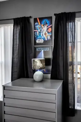 a room with a dresser with two posters on the wall at Newly Renovated Stylish Villa with Star Wars Mickey and Safari Themed Rooms #3TV4706 in Kissimmee