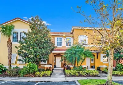 a large yellow house with palm trees at Newly Renovated Stylish Villa with Star Wars Mickey and Safari Themed Rooms #3TV4706 in Kissimmee