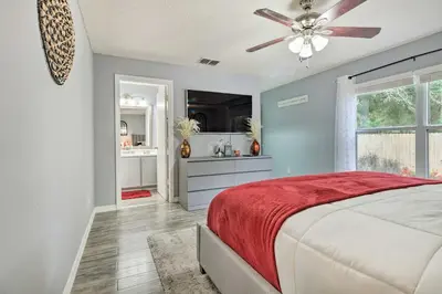 a bedroom with a bed and a ceiling fan at Chic Orlando Family Getaway with Fenced Yard! in Orlando