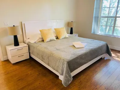 a bedroom with a bed with two night stands and two lamps at Luxury • Modern • CLOSE2DISNEY • 3bed • 2bath in Kissimmee