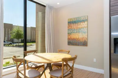 a dining room with a table and chairs and a window at 4 Suites - 5 min from Disney - w Jacuzzi 7557 in Orlando
