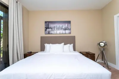a bedroom with a white bed and a window at 4 Suites - 5 min from Disney - w Jacuzzi 7557 in Orlando