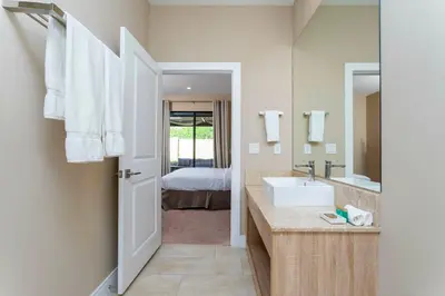 a bathroom with a sink and a mirror at 4 Suites - 5 min from Disney - w Jacuzzi 7557 in Orlando