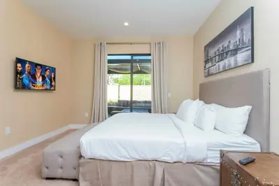 a bedroom with a large white bed and a window at 4 Suites - 5 min from Disney - w Jacuzzi 7557 in Orlando