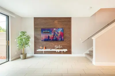 a living room with a painting on the wall at 3BR Resort Pool Jacuzzi Minutes to Disney 4730 in Kissimmee