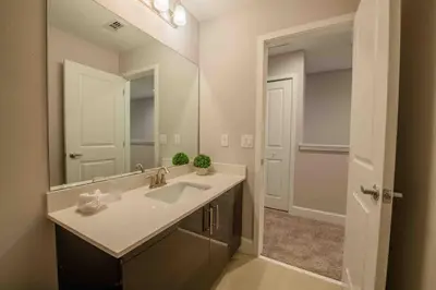 a bathroom with a sink and a large mirror at 3BR Resort Pool Jacuzzi Minutes to Disney 4730 in Kissimmee