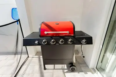 a red toaster sitting on top of a stove at Private Pool Villa Family Retreat Near Disney World in Orlando