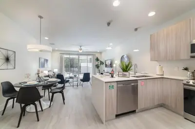 a kitchen and living room with a table and chairs at Private Pool Villa Family Retreat Near Disney World in Orlando