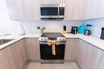 a kitchen with a stove with a bow on it at Private Pool Villa Family Retreat Near Disney World in Orlando