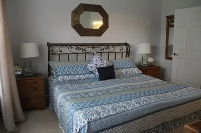 a bedroom with a bed with a laptop on it at Veteran Owned 3bdr/3 bath Townhouse w/WiFi 3mi to Disney - Fall/Winter Specials in Kissimmee