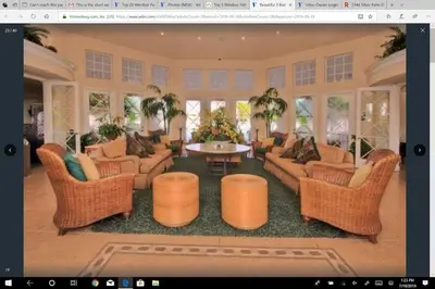 a large living room with wicker chairs and a table at Veteran Owned 3bdr/3 bath Townhouse w/WiFi 3mi to Disney - Fall/Winter Specials in Kissimmee