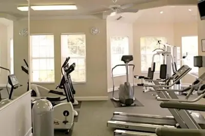 a gym with several treadmills and elliptical machines at Veteran Owned 3bdr/3 bath Townhouse w/WiFi 3mi to Disney - Fall/Winter Specials in Kissimmee