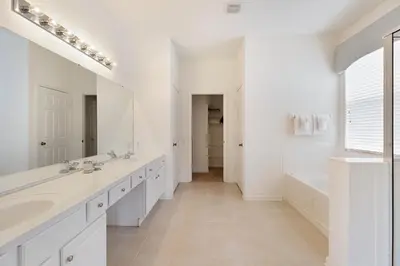 a white bathroom with two sinks and a mirror at Windsor Dream - 6 bedroom resort pool home in Orlando